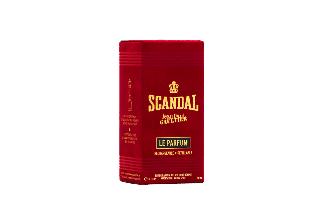 Fragancia de perfume en envase de latón de color rojo con diseño elegante y texto en dorado y negro.