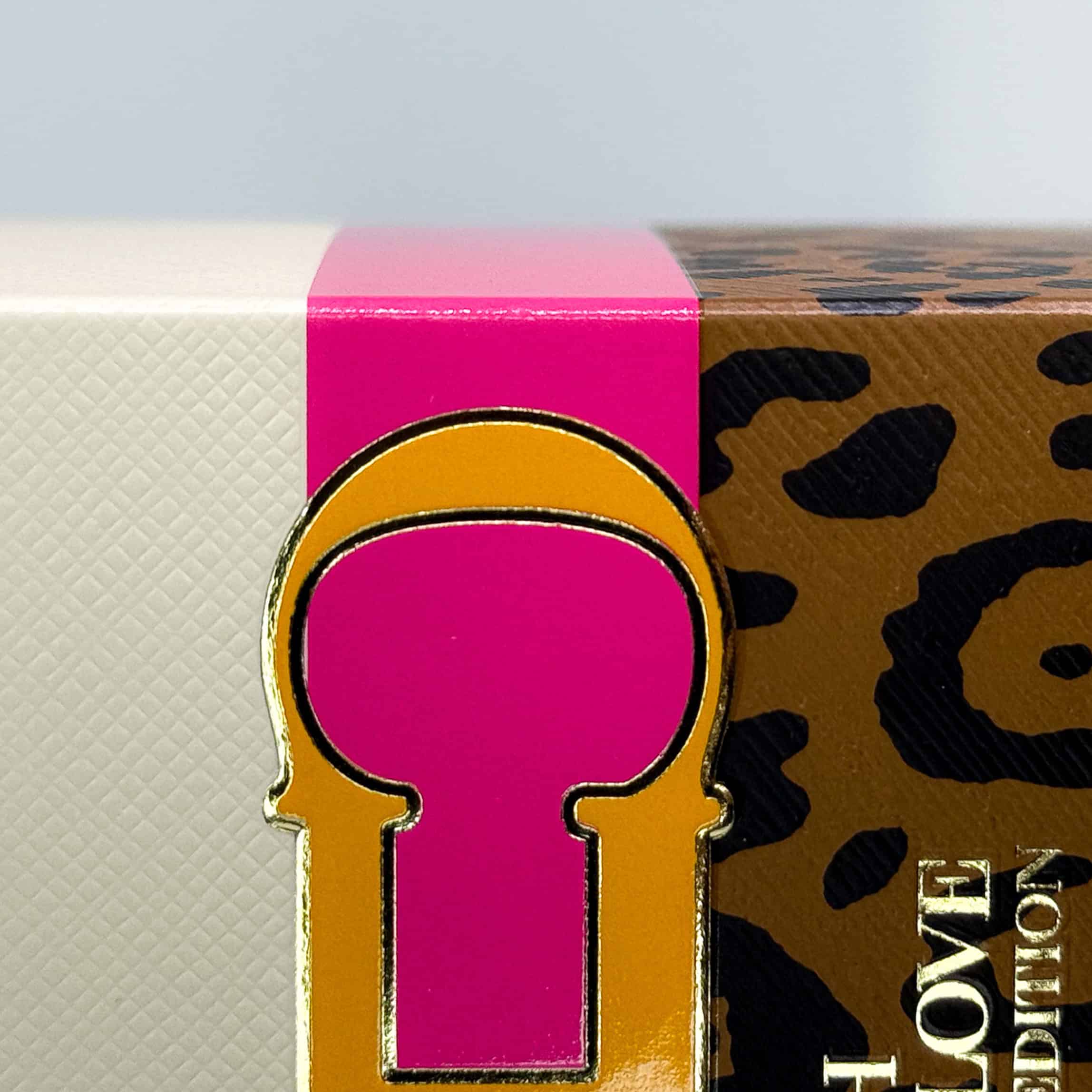 Detailed box with leopard-textured debossing and embossed packaging on the gold magnetic closure.